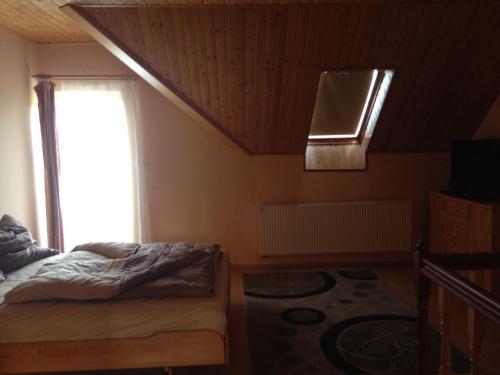 a bedroom with a bed and a window at Daja Ház in Hévíz