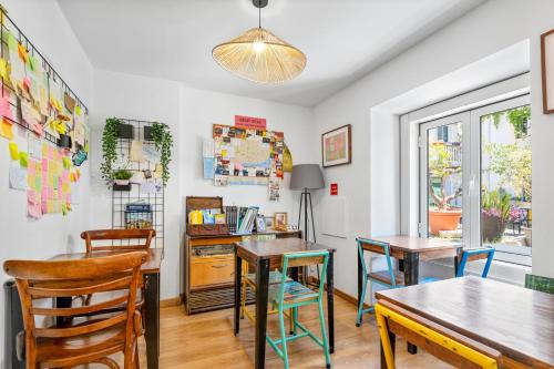 a dining room with two tables and chairs at Casa do Patio by Shiadu in Lisbon