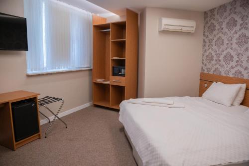 a hotel room with a bed and a television at The MU City Hotel Trabzon in Trabzon