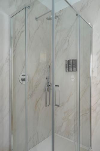 a shower with a glass door in a bathroom at Civita Living in Civitanova Marche