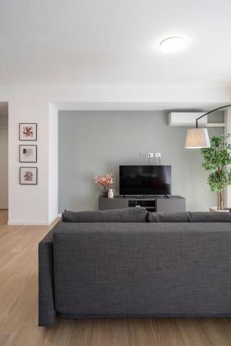 a living room with a couch and a tv at Civita Living in Civitanova Marche