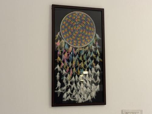 a picture of a peacock painting on a wall at Le Park Luxury Resort - TIE Hotels & Resorts in Puducherry