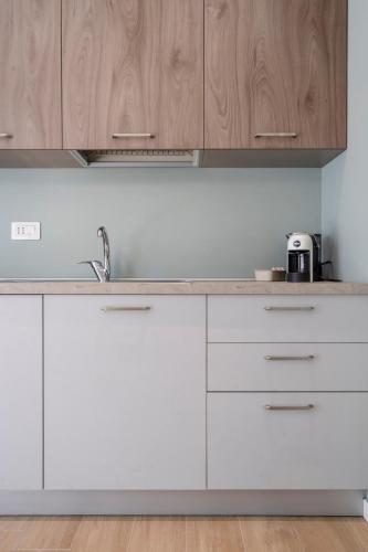 a kitchen with white cabinets and a sink at Civita Living in Civitanova Marche