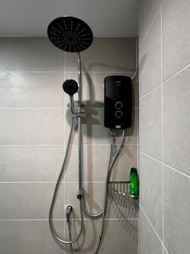a shower in a bathroom with a shower at Summermall suits samarahan in Kota Samarahan