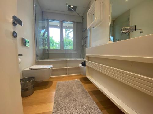 a bathroom with a toilet and a sink and a window at Il sogno Forte dei Marmi in Forte dei Marmi