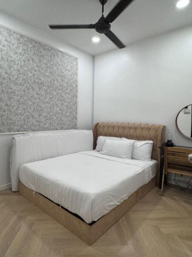 a bedroom with a bed with a ceiling fan at Angsamas Villa Seremban Kids Private Pool in Seremban