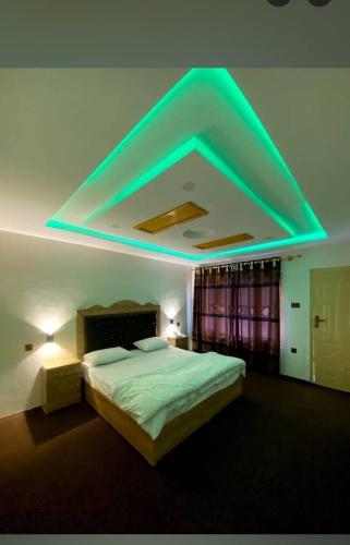 a bedroom with a bed with a blue light at Tourist haven hotel in Ponedas