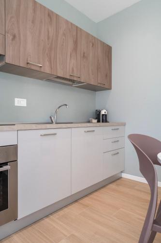 a kitchen with white cabinets and a sink at Civita Living in Civitanova Marche