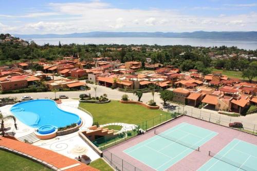 an aerial view of a resort with a tennis court at ANANA El Dorado 305 | Pool & Lake Views in Ajijic
