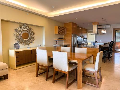 a kitchen and dining room with a wooden table and chairs at ANANA El Dorado 305 | Pool & Lake Views in Ajijic