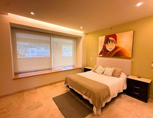 a bedroom with a bed and a large window at ANANA El Dorado 305 | Pool & Lake Views in Ajijic