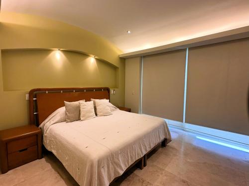 a bedroom with a bed and a large window at ANANA El Dorado 305 | Pool & Lake Views in Ajijic