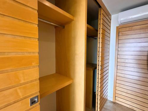 a room with wooden shelves and a door at ANANA El Dorado 305 | Pool & Lake Views in Ajijic