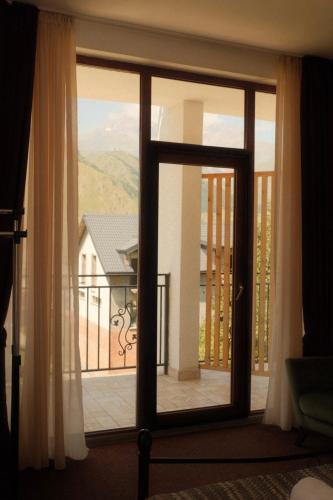 a view of a room with a door open to a balcony at Mood Hotel Kazbegi in Stepantsminda