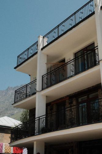 a building with balconies on the side of it at Mood Hotel Kazbegi in Stepantsminda