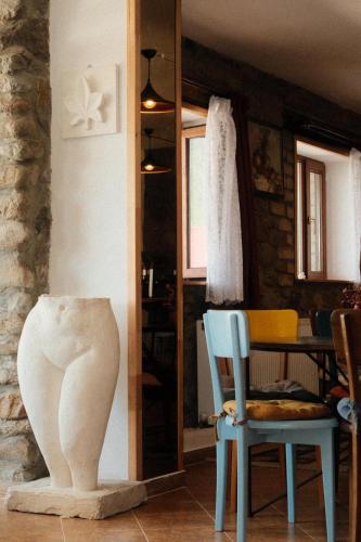 a room with two chairs and a vase on the floor at Mood Hotel Kazbegi in Stepantsminda