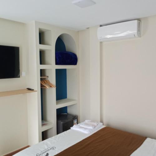 a small bedroom with a bed and a tv at MDE Loisir Tanjis m in Tangier