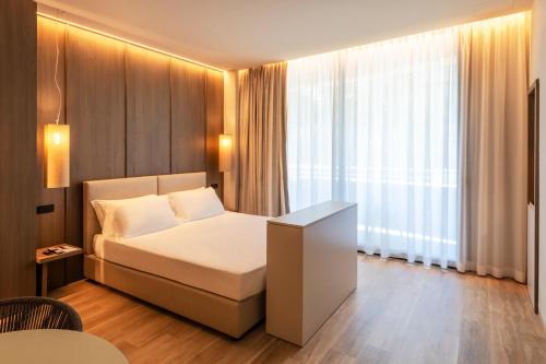 a hotel room with a bed and a window at International Hotel & Suite in San Benedetto del Tronto