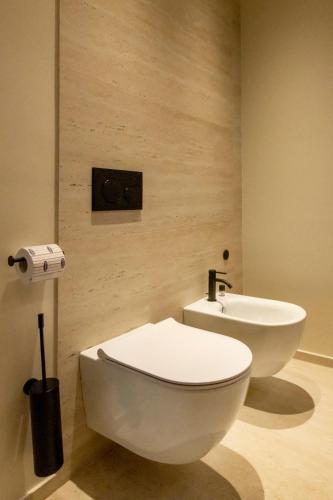 a bathroom with a white toilet and a sink at International Hotel & Suite in San Benedetto del Tronto