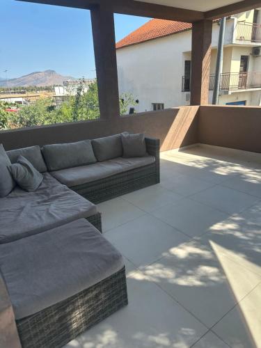 a couch sitting on top of a patio at Dasic apartments in Podgorica