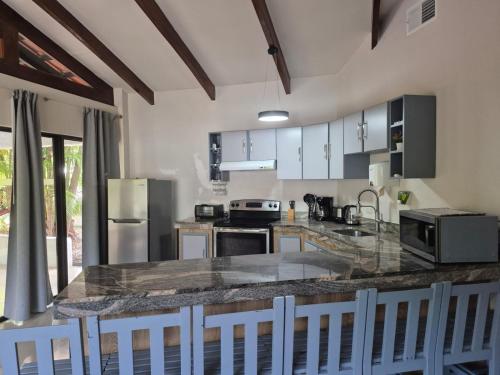 a kitchen with a granite counter top and appliances at MonteMar Beach Condo At Playa hermosa in Sardinal