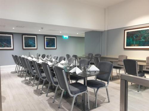 a conference room with a long table and chairs at Hilton London Kensington Hotel in London