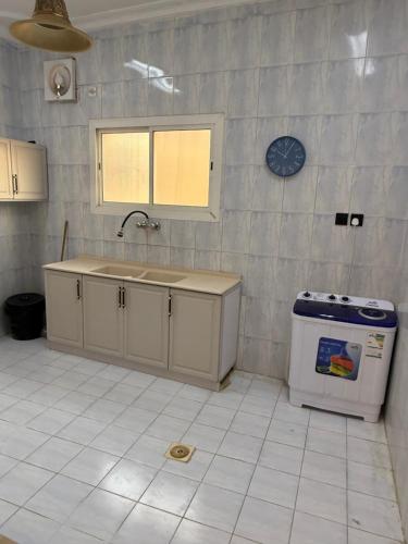 a kitchen with a sink and a stove in it at قصر الضيافه in Al Madinah