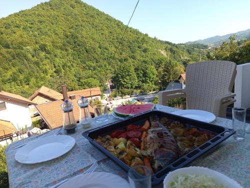a table with a tray of food on top at Apartman Emma in Visoko