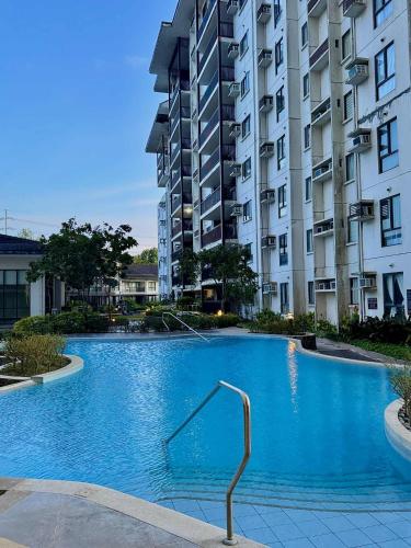 a large swimming pool in front of a building at Tagaytay Staycation with Great Location in Tagaytay