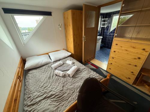 a small bedroom with a bed with towels on it at VITA Augustów in Augustów