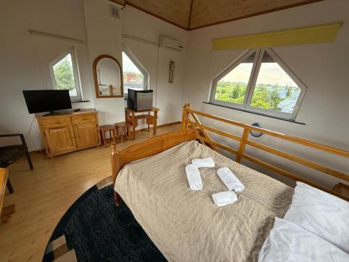 a bedroom with a bed with two towels on it at VITA Augustów in Augustów