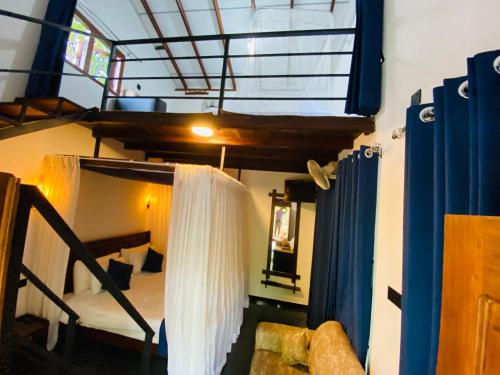 a room with a bunk bed and a window at Rest Full Homestay in Ella