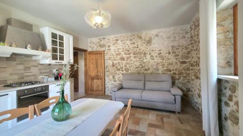 a kitchen and dining room with a table and a couch at Il Casale di Papà in Piemonte