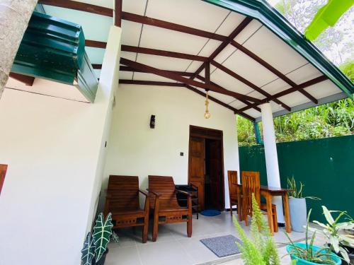 a patio with chairs and a pergola at Rest Full Homestay in Ella