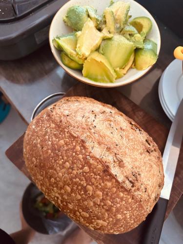a plate of bread and a bowl of vegetables on a counter at Ananda Home in Tân Hiệp