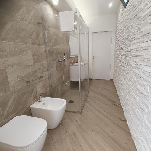 a bathroom with a toilet and a shower and a sink at Villa Mare Luna in Balestrate
