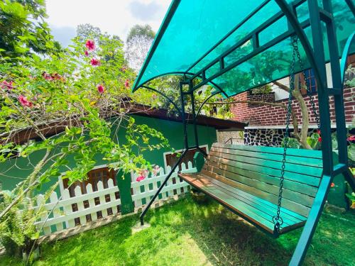 a blue bench sitting next to a white fence at Rest Full Homestay in Ella