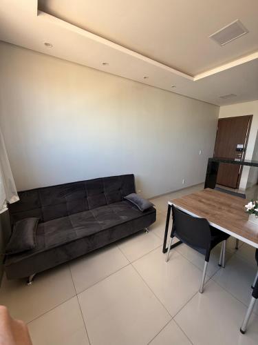 a living room with a couch and a table at Apartamento Frente à Praia da Graciosa in Palmas