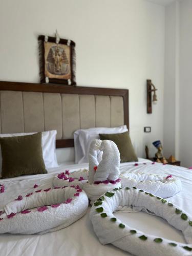 a bed with two towels and a stuffed animal on it at Are Pyramids View in Cairo