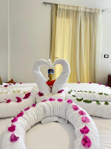 a bed with two swans made out of towels at Are Pyramids View in Cairo