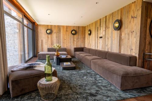 a living room with a couch and a table at Hôtel L'Arboisie in Megève