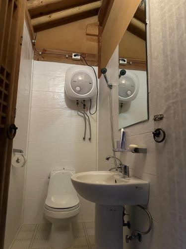 a small bathroom with a toilet and a sink at Korean Traditional House - Chungnokdang in Boseong