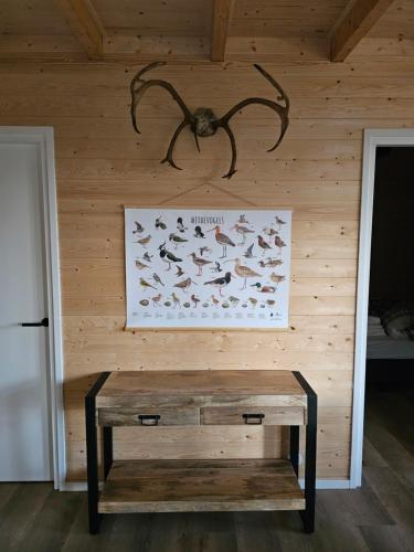 a wooden wall with a picture of fish on it at Bungalow de Grutto in Schoonloo