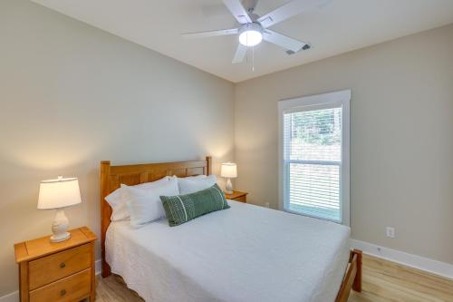 a bedroom with a bed with a ceiling fan and a window at Near 17 Springs Sports Complex Millbrook Duplex! in Millbrook