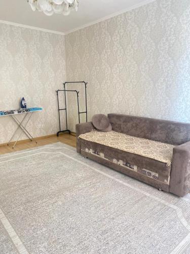 a living room with a couch and a rug at 2 комнатная квартира золотой квадрат ЖК Москва in Astana