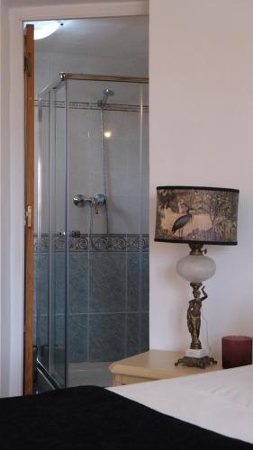 eine Glasdusche in einem Schlafzimmer mit einer Lampe in der Unterkunft Authentic Andalusian Boho Villa - Pool - Garden-BBQ- 7 Guests in Benalmádena