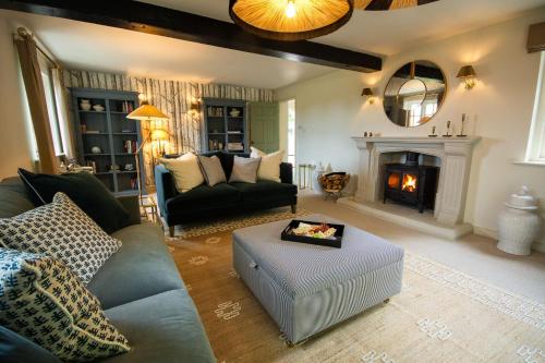 a living room with a couch and a fireplace at Sandstone 34 in Chester