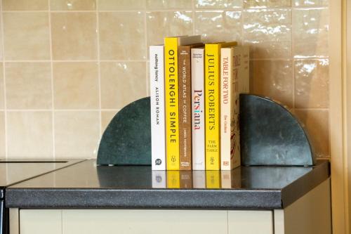 a row of books sitting on top of a counter at Sandstone 34 in Chester