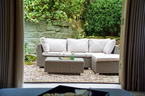 a living room with a couch and a table at Sandstone 34 in Chester