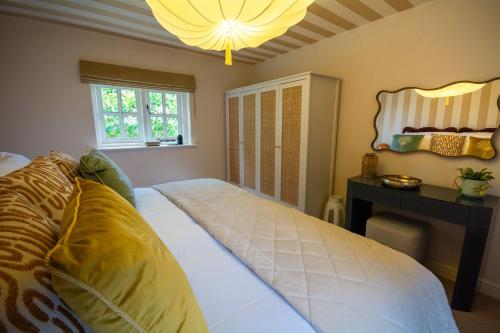 a bedroom with a bed and a table and a window at Sandstone 34 in Chester